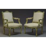 A pair of Louis XV style yellow and green painted fauteuils, mid 20th Century, the shaped back