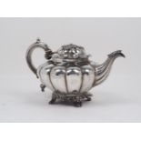 A Victorian silver melon-shaped teapot, London, c.1843, maker's mark rubbed, the lobed body raised
