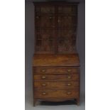 A George III mahogany bureau bookcase, the moulded cornice above two astragal glazed doors enclosing