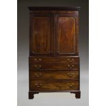 A George III mahogany linen press secretaire, the dentil moulded cornice above two panelled and