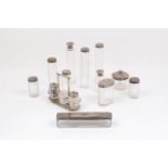 A collection of silver topped glass vanity jars, comprising a set of five jars of various shape with