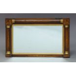 A Regency rosewood and marquetry inlaid wall mirror, the rectangular plate set within gilt slip, the