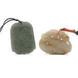 A Chinese pale green jade carving, of animalistic form, 5cm long with attached string necktie, a