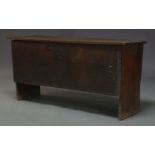 An 18th Century oak coffer, with chip carved decoration, the hinged lid enclosing candle box and