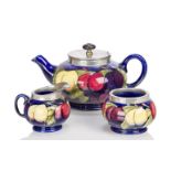 William Moorcroft (1872-1945), a pewter mounted earthenware 'Wisteria' pattern tea set c.1925,