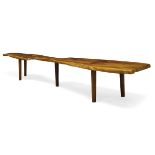 In the manner of George Nakashima, a yew wood bench late 20th Century With free edge, raised on five