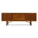 A teak sideboard, probably Scandinavian c.1960 With four drawers flanked by two cupboard doors,