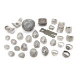 A collection of Chinese silver rings and white metal ingots, 20th century, (29)Please refer to