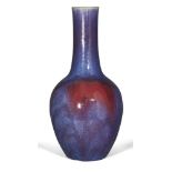 A large Chinese grey stoneware flambe glazed bottle vase, 19th century, the slender neck richly