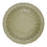 A Chinese Longquan celadon dish, Ming dynasty, with a foliate rim and incised floral decoration