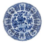 A Chinese porcelain dish, Kangxi period, painted in underglaze blue with flowering peony blooms to