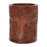 A Chinese bamboo immortals brush pot, 19th century, carved with the Eight Immortals in a pine