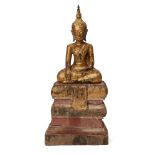 A Cambodian gilded and lacquered wood Buddha, 19th century, raised on a stepped pedestal, 32cm