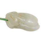 A Chinese pale green jade pendant, 19th century, carved as a leafy branch issuing two fruit, with