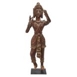 A large Burmese teak standing princely figure, Pagan Area, lacquered and glass inlaid, wearing
