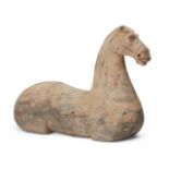 A Chinese grey pottery horse, Han dynasty, modelled without legs and holes to insert the tail and