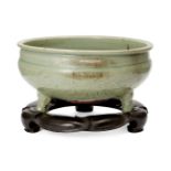A large Chinese grey stoneware Longquan celadon tripod censer, Ming dynasty, carved to the