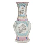 A Chinese porcelain hexagonal vase, Qianlong period, painted in famille rose enamels with panels
