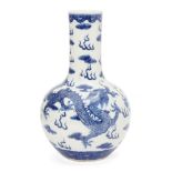 A Chinese porcelain bottle vase, Republic period, painted in underglaze blue with two dragons