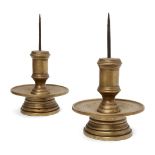 A pair of Tibetan bronze pricket candlesticks, 17th/18th century, of circular form, decorated with