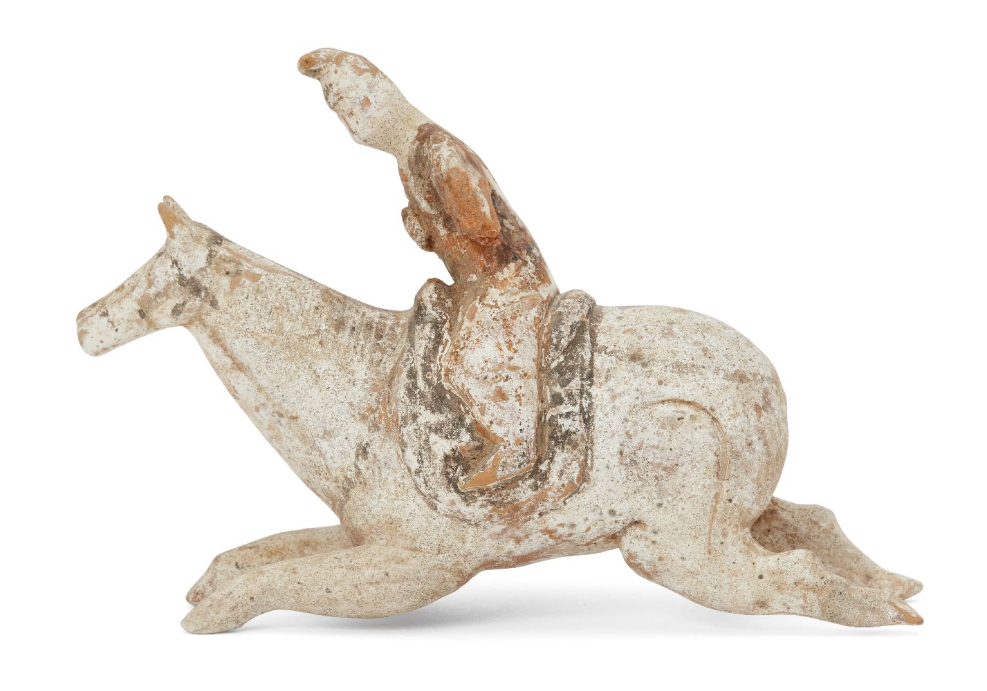 A Chinese miniature pottery figure of a polo player, Tang dynasty, in full gallop, painted in
