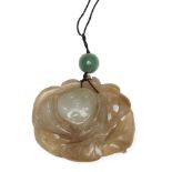 A Chinese celadon jade lotus pendant, early 20th century, carved to both sides with a lotus pod