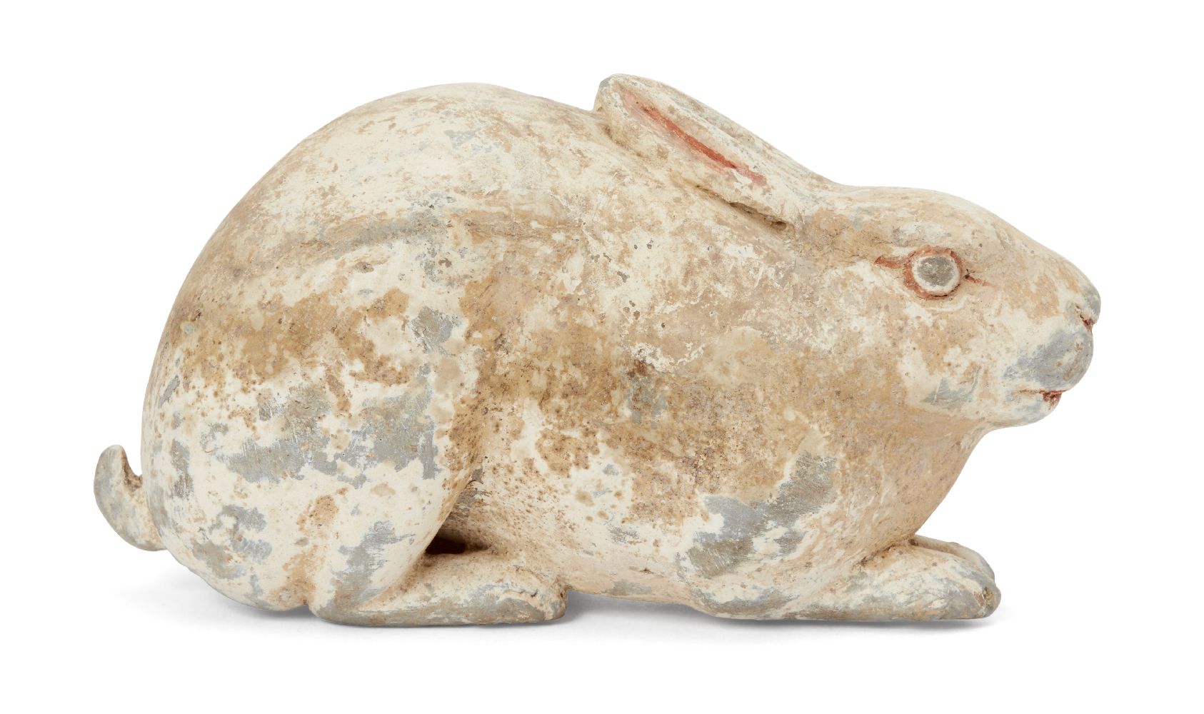 A Chinese grey pottery hare, Han dynasty, modelled crouching facing forwards in alert pose with long