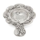 A Chinese silver petal-shaped tea strainer, Tuck Chang &Co., applied to the rim with blossoming