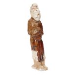 A Chinese pottery sancai glazed figure of an attendant, Tang dynasty, partially lead-glazed in