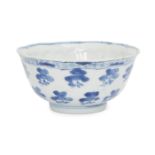 A Chinese porcelain moulded bowl, Kangxi period, painted in underglaze blue with floral sprays to