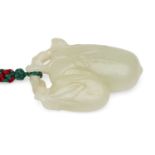 A Chinese pale green jade fruit pendant, late 19th century, carved as a leafy branch issuing two