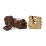 Two Chinese hardstone carvings, early 20th century, one carved as a recumbent dog, 6.5cm long, the