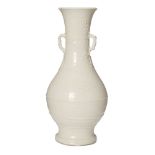 A Chinese Dehua porcelain vase, 18th/19th century, applied to the neck with branch handles with