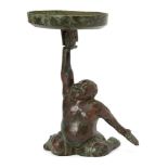 A Chinese bronze figural candleholder, Western Han dynasty, cast as a kneeling 'entertainer' holding