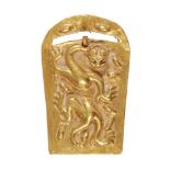 A Chinese gold belt buckle, Han dynasty, chased in high relief with a chilong dragon, the edges of