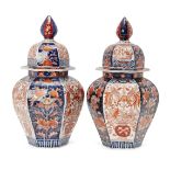 A pair of Japanese imari porcelain hexagonal jars and covers, 18th century, painted with alternating