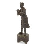 A Chinese bronze incense holder, 17th century, modelled as a boy holding up a tripod censer as a