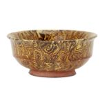 A Chinese marbled-pottery bowl, Tang dynasty, with steep straight sides to flared rim, covered in