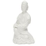 A Chinese porcelain blanc-de-chine figure of Guanyin, Republic period, depicted seated, with long