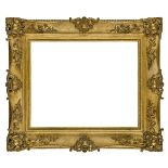 A Gilded Composition Louis XV Style Swept and Pierced Style Frame, mid-19th century, with cavetto