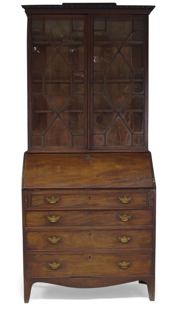 A George III mahogany bureau bookcase, the moulded cornice above two astragal glazed doors enclosing