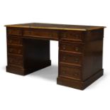 A mahogany pedestal desk, early 19th Century, the rounded rectangular top inset with green leather