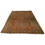 A Heriz carpet, early 20th Century, the brick red field with all over design, mustard coloured