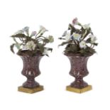 A pair of continental porcelain flower urns, 19th century, each campana urn simulating porphyry