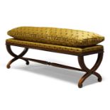 A long stool, late 20th Century, with loose cushion, upholstered in mustard coloured fabric,
