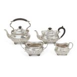 A matched silver four-piece tea service, the teapot and tea kettle Birmingham, c.1910, SW Smith