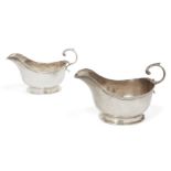 A pair of silver sauce boats, London, c.1925, Asprey & Co., the plain body of each raised on an oval