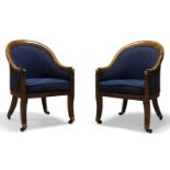 A pair of Regency faux rosewood bergere armchairs, the curved backrest and armrests terminating in