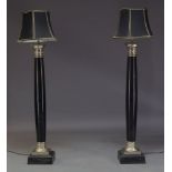 A pair of modern steel and ebonised standard lamps, of recent manufacture, each of tapering columnar