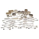 A group of small silver including: nine silver napkin rings, a set of ten coffee spoons with